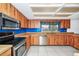 Spacious kitchen with wood cabinetry, stainless steel appliances, and an undermount sink at 3379 Monika Cir, Orlando, FL 32812