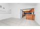 Open-concept living room with tile floors adjacent to a kitchen with wood cabinetry and stainless steel appliances at 3379 Monika Cir, Orlando, FL 32812