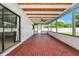 Covered patio with brick flooring, ceiling fan, and screen enclosure, offering an outdoor living space at 3379 Monika Cir, Orlando, FL 32812
