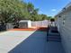 Backyard features a gray deck, shed on mulch, new white fence, and partial view of house at 37518 Quail Ridge Cir, Leesburg, FL 34788