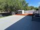 Expansive backyard features a gray deck, a shed on mulch, and a well-maintained fence at 37518 Quail Ridge Cir, Leesburg, FL 34788