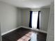 This bedroom features hardwood floors, a modern light fixture, and beautiful natural light at 37518 Quail Ridge Cir, Leesburg, FL 34788