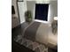Serene bedroom with a minimalist aesthetic, featuring a large TV, dresser, and plant at 37518 Quail Ridge Cir, Leesburg, FL 34788