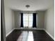 This bedroom features hardwood floors, a modern light fixture, and beautiful natural light at 37518 Quail Ridge Cir, Leesburg, FL 34788