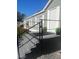 Charming front porch with painted steps, black railing, potted plants, and a welcoming entrance at 37518 Quail Ridge Cir, Leesburg, FL 34788