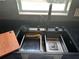 Modern kitchen sink with stainless steel basin, black faucet, and included accessories by a window at 37518 Quail Ridge Cir, Leesburg, FL 34788