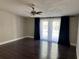 Living room area showcasing an updated ceiling fan, french doors and hardwood floors at 37518 Quail Ridge Cir, Leesburg, FL 34788