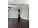 Bright living room features updated dark wood flooring and neutral paint palette with open doorway at 37518 Quail Ridge Cir, Leesburg, FL 34788