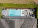 Aerial view of a private backyard oasis featuring a sparkling pool, lounge area, and manicured landscaping at 3883 Grassland Loop, Lake Mary, FL 32746
