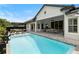 Wide backyard view showcasing a pristine pool, patio, and covered outdoor dining area for entertaining at 3883 Grassland Loop, Lake Mary, FL 32746