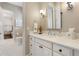 Bathroom features marble countertops, white cabinetry, updated lighting, and decorative accessories at 3883 Grassland Loop, Lake Mary, FL 32746