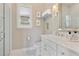 Bright bathroom boasts a glass shower, white vanity with marble countertop, and a framed mirror at 3883 Grassland Loop, Lake Mary, FL 32746