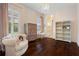 Bedroom features hard wood flooring, white walls, chandelier and custom decor at 3883 Grassland Loop, Lake Mary, FL 32746