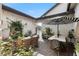 Beautiful courtyard with seating, flowers, plants and a black-and-white striped umbrella for shade at 3883 Grassland Loop, Lake Mary, FL 32746