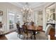 Elegant dining room featuring French doors, decorative chandelier, and a view of the patio at 3883 Grassland Loop, Lake Mary, FL 32746