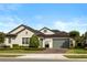 Charming single-story home featuring a well-manicured lawn, gray paint, and a two-car garage at 3883 Grassland Loop, Lake Mary, FL 32746