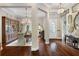 Elegant foyer showcasing hardwood floors, a decorative chandelier, and an adjacent dining area at 3883 Grassland Loop, Lake Mary, FL 32746