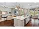 Gourmet kitchen with an island, stainless appliances, and breakfast nook offering views of the outdoor living space at 3883 Grassland Loop, Lake Mary, FL 32746