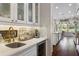 The kitchen features a built-in bar area with custom cabinets and a beverage center, perfect for entertaining at 3883 Grassland Loop, Lake Mary, FL 32746