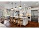 Spacious kitchen island, pendant lights, white cabinets, and hardwood flooring at 3883 Grassland Loop, Lake Mary, FL 32746
