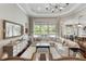 Open-concept living room with hardwood floors and plenty of natural light flowing through sliding glass doors at 3883 Grassland Loop, Lake Mary, FL 32746