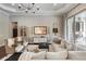 A spacious living room with comfortable seating, decorative lighting, and sophisticated decor for relaxed living at 3883 Grassland Loop, Lake Mary, FL 32746