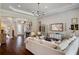 Inviting living room with hardwood floors, decorative chandelier, and comfortable seating at 3883 Grassland Loop, Lake Mary, FL 32746