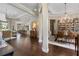 Open-concept living space with hardwood floors, coffered ceilings, and a seamless flow to the kitchen at 3883 Grassland Loop, Lake Mary, FL 32746