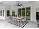Covered outdoor dining area featuring a modern table set and a ceiling fan for comfortable dining at 3883 Grassland Loop, Lake Mary, FL 32746