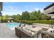 Resort-style outdoor living area with a refreshing pool, lounge furniture, and manicured landscaping at 3883 Grassland Loop, Lake Mary, FL 32746
