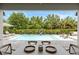 Beautiful view of the pool area from the outdoor dining area with comfortable lounge seating at 3883 Grassland Loop, Lake Mary, FL 32746