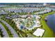 Stunning aerial view of community amenities with lazy river, swimming pools, and beach volleyball court at 4772 Kings Castle Cir, Kissimmee, FL 34746
