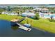 A dock on the lake with kayak rentals complements the beautiful landscaping and community amenities at 4772 Kings Castle Cir, Kissimmee, FL 34746