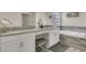 Elegant bathroom featuring double sinks, granite countertops, and a separate soaking tub at 4772 Kings Castle Cir, Kissimmee, FL 34746