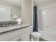Full bathroom features a granite countertop vanity, tub, and shower at 4772 Kings Castle Cir, Kissimmee, FL 34746
