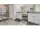 Stylish bathroom with a glass-enclosed shower and double granite vanity at 4772 Kings Castle Cir, Kissimmee, FL 34746