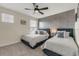 Well-lit bedroom with two twin beds, a ceiling fan, and modern decor at 4772 Kings Castle Cir, Kissimmee, FL 34746