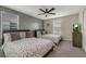 Comfortable bedroom with two beds, a ceiling fan, and a gray accent wall at 4772 Kings Castle Cir, Kissimmee, FL 34746