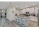 Open kitchen with a center island, stainless steel appliances, and access to other areas of the home at 4772 Kings Castle Cir, Kissimmee, FL 34746