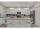 Modern kitchen with stainless steel appliances, granite countertops, and a breakfast bar with seating at 4772 Kings Castle Cir, Kissimmee, FL 34746