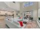 Bright living room featuring high ceilings, modern furniture, and sliding glass doors to the outdoor patio at 4772 Kings Castle Cir, Kissimmee, FL 34746