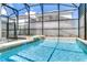 Sparkling pool in screened enclosure features a built-in spa and ample space for recreation at 4772 Kings Castle Cir, Kissimmee, FL 34746