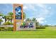 Well-manicured entry sign for Storey Lake features vibrant landscaping and clear community branding at 4772 Kings Castle Cir, Kissimmee, FL 34746