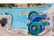 Aerial view of community water slides and lazy river, surrounded by palm trees and lush greenery at 4772 Kings Castle Cir, Kissimmee, FL 34746