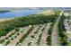 Aerial view of a residential neighborhood featuring tree-lined streets and a nearby lake, promising scenic beauty at 4793 Grassy Knoll Dr, Tavares, FL 32778