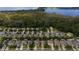 A high angle aerial view of a well-organized neighborhood with lush trees and a view of a tranquil lake at 4793 Grassy Knoll Dr, Tavares, FL 32778