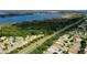 Community aerial showcasing residences next to the highway, lake and wooded area at 4793 Grassy Knoll Dr, Tavares, FL 32778
