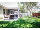 Inviting backyard with a screened-in patio and lush green grass at 4793 Grassy Knoll Dr, Tavares, FL 32778