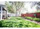 Beautiful backyard with a well-maintained lawn, brick wall, garden bed, and privacy fence at 4793 Grassy Knoll Dr, Tavares, FL 32778