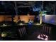 Backyard with a fire pit, brick wall, and landscape lighting at 4793 Grassy Knoll Dr, Tavares, FL 32778